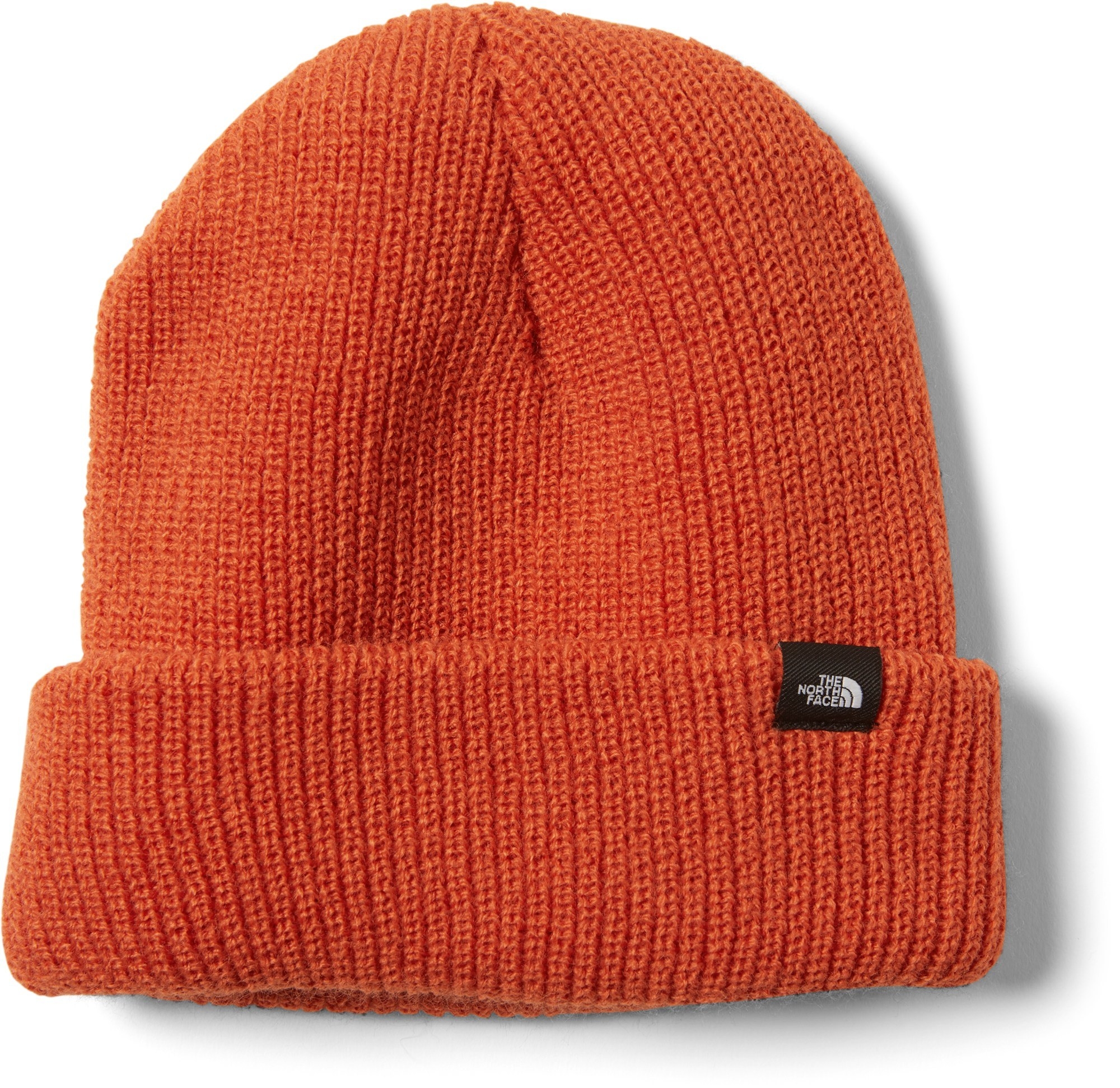 orange knit beanie wiht a small north face logo label