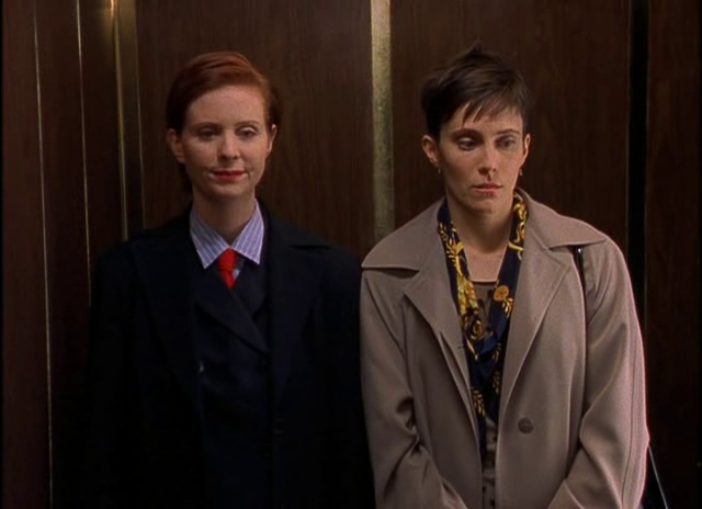 Miranda standing in an elevator with another woman in a scene from the original series