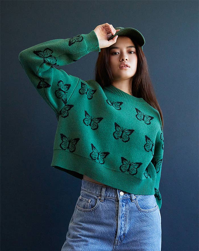 green sweater with black butterfly pattern