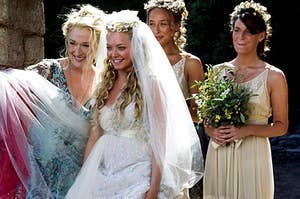 sophie in her wedding dress with her bridesmaids and her mom