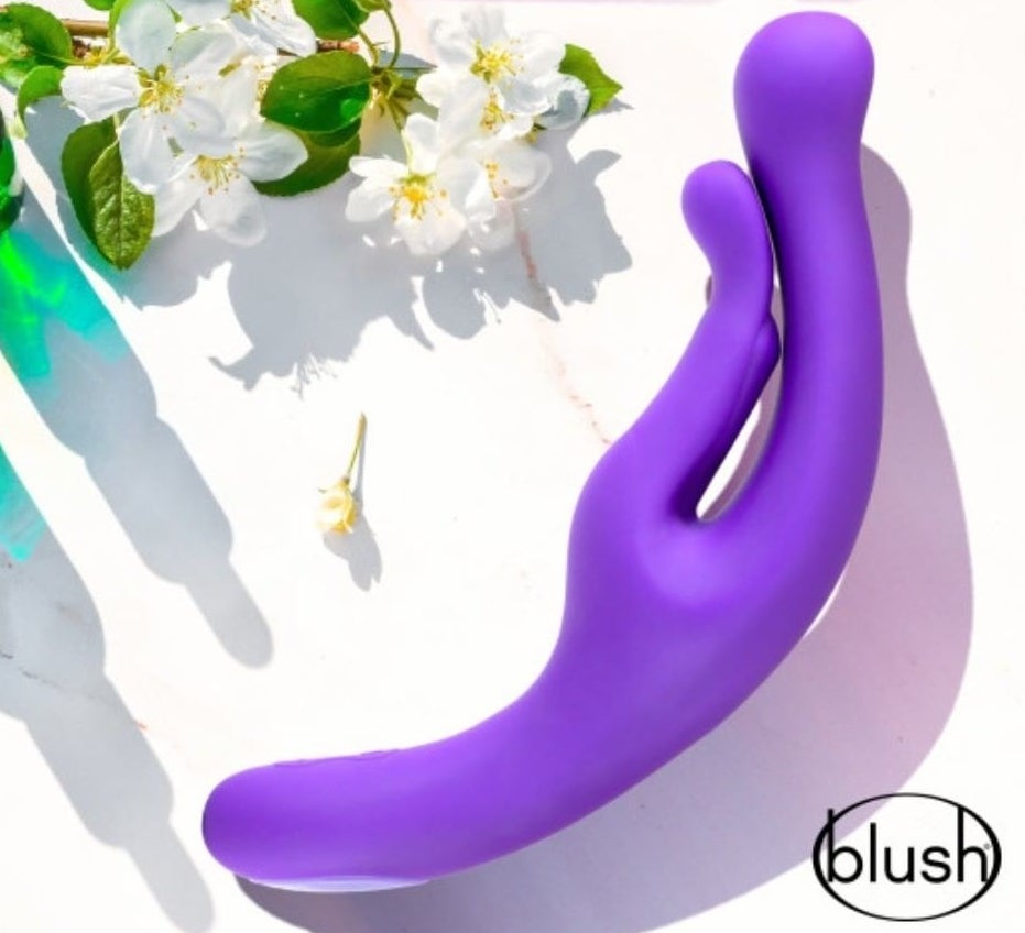 Purple abstract rabbit vibrator next to flowers