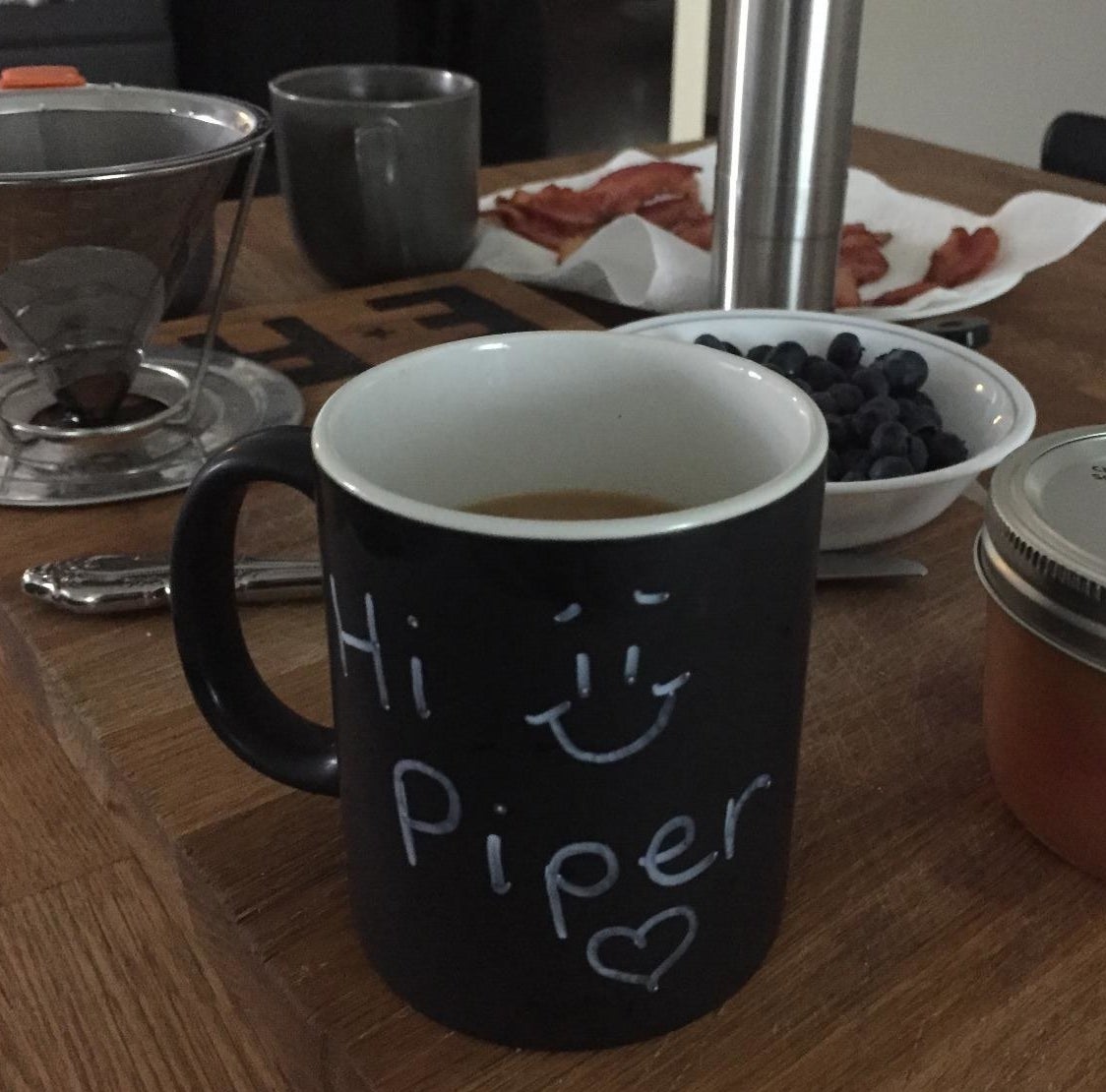 Reviewer photo of the chalkboard mug on a breakfast table with the words &quot;Hi Piper&quot; written on it