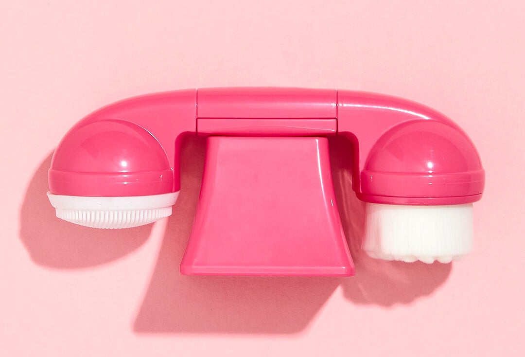 a double ended cleansing brush that looks like a landline phone
