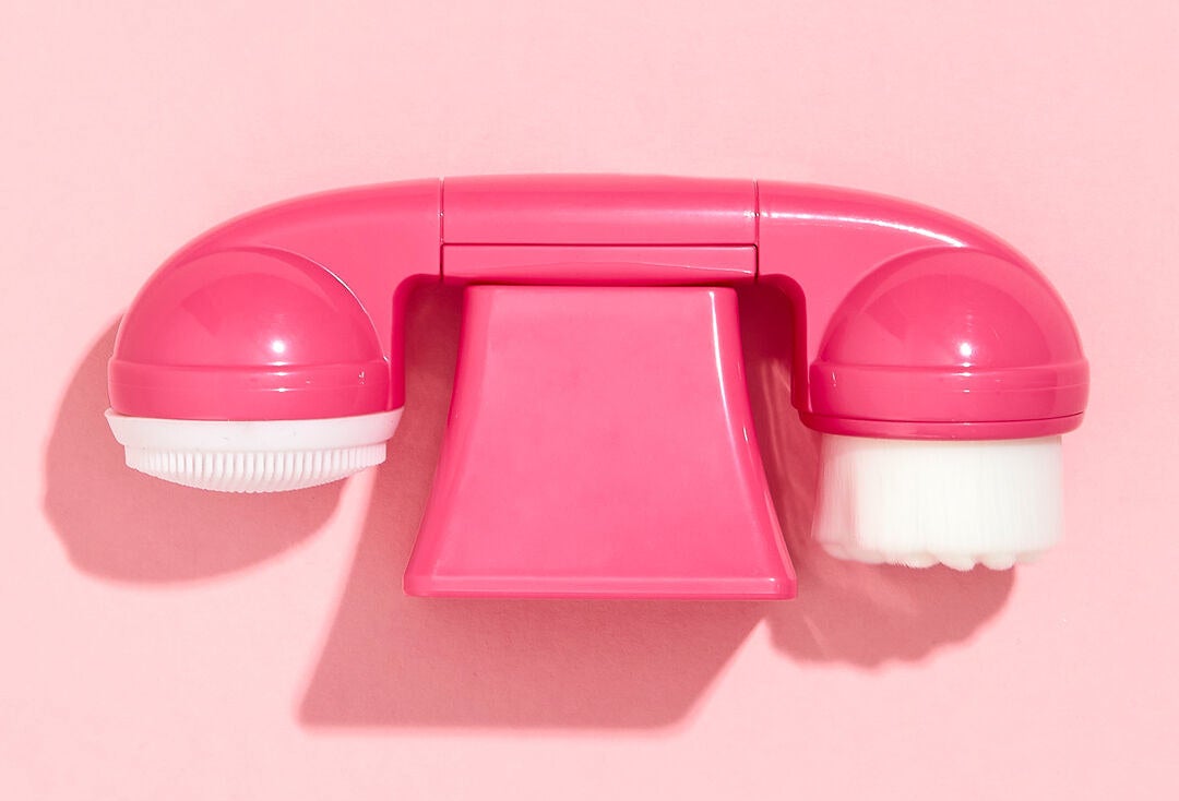 a double ended cleansing brush that looks like a landline phone