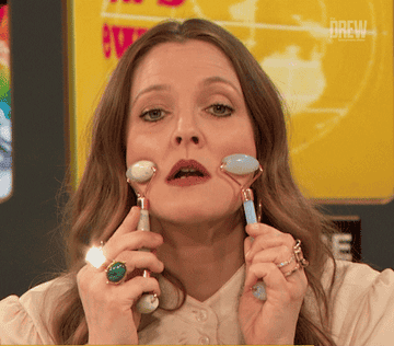 Drew Barrymore using two face rollers on &quot;The Drew Barrymore Show&quot;