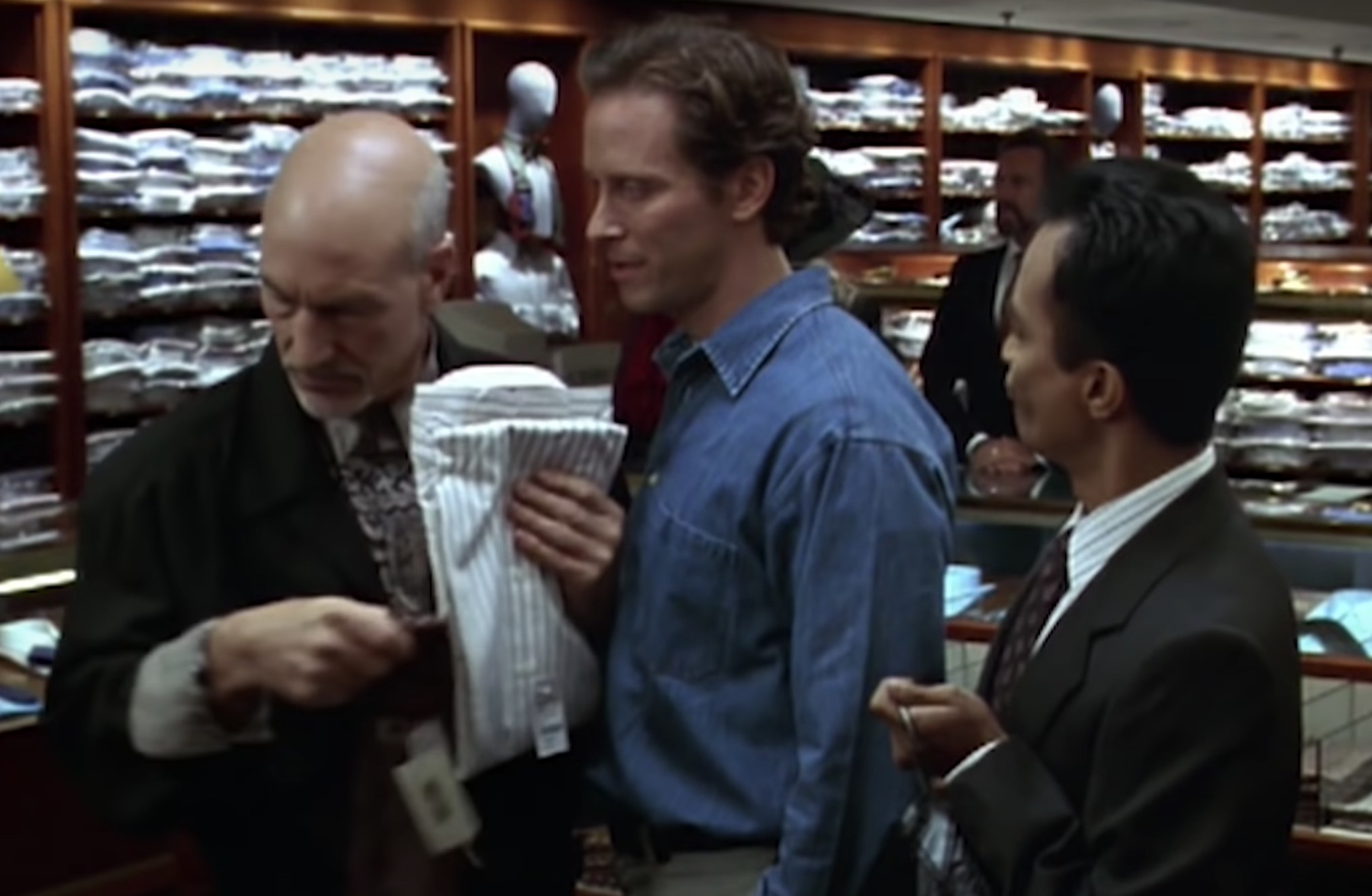 Actors Patrick Stewart and Steven Weber shop in the men&#x27;s section of a store with a sales associate.