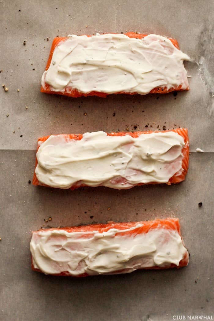 Three salmon fillets topped with Greek yogurt.