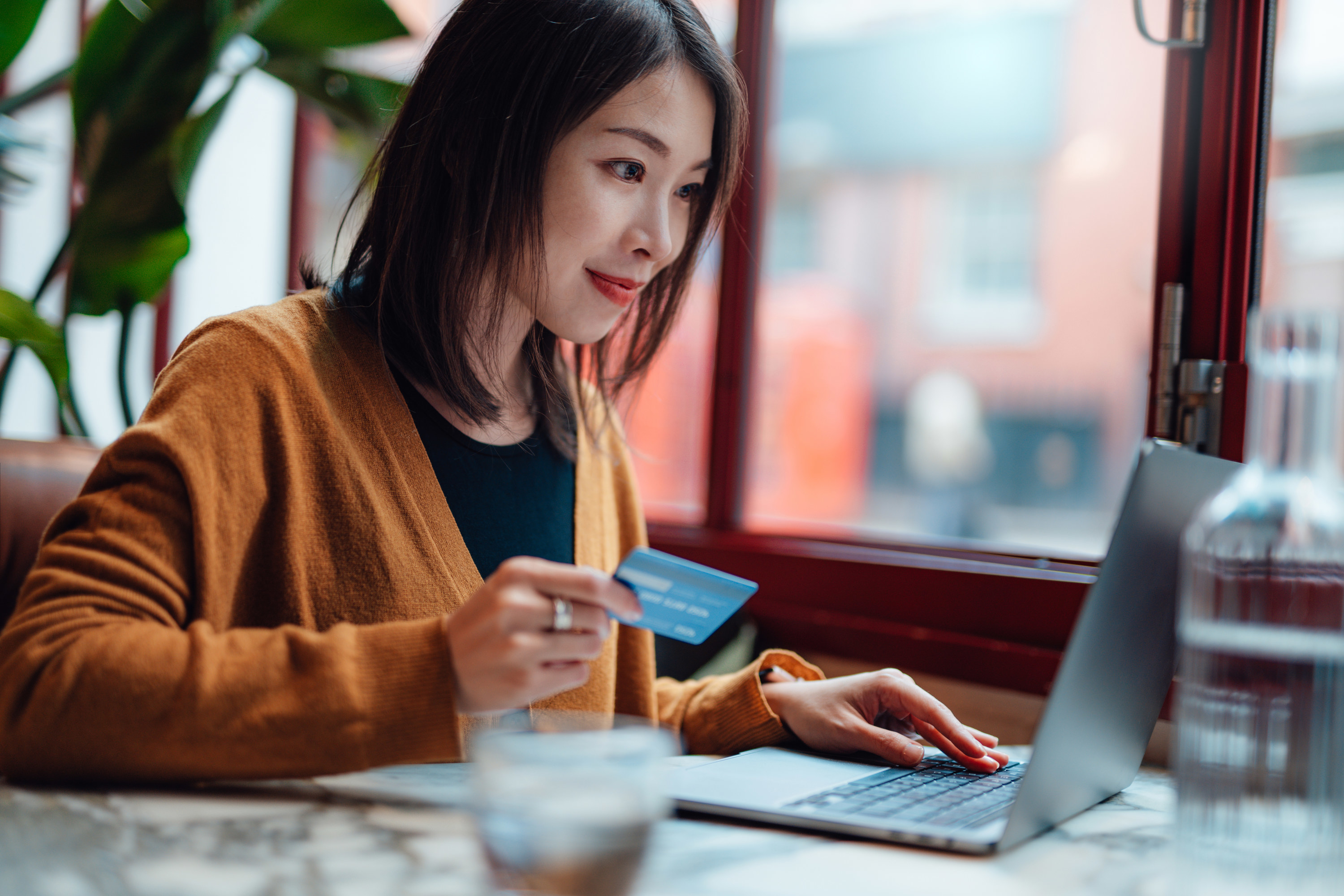 Woman shopping online with a credit card