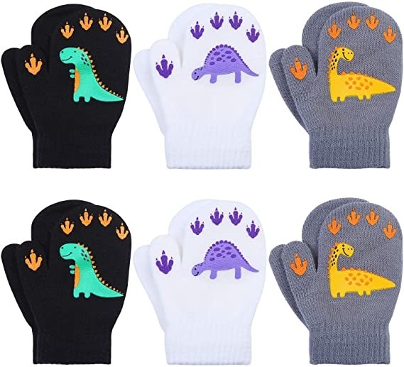 An image of a six pairs of toddler mittens with dinos on them
