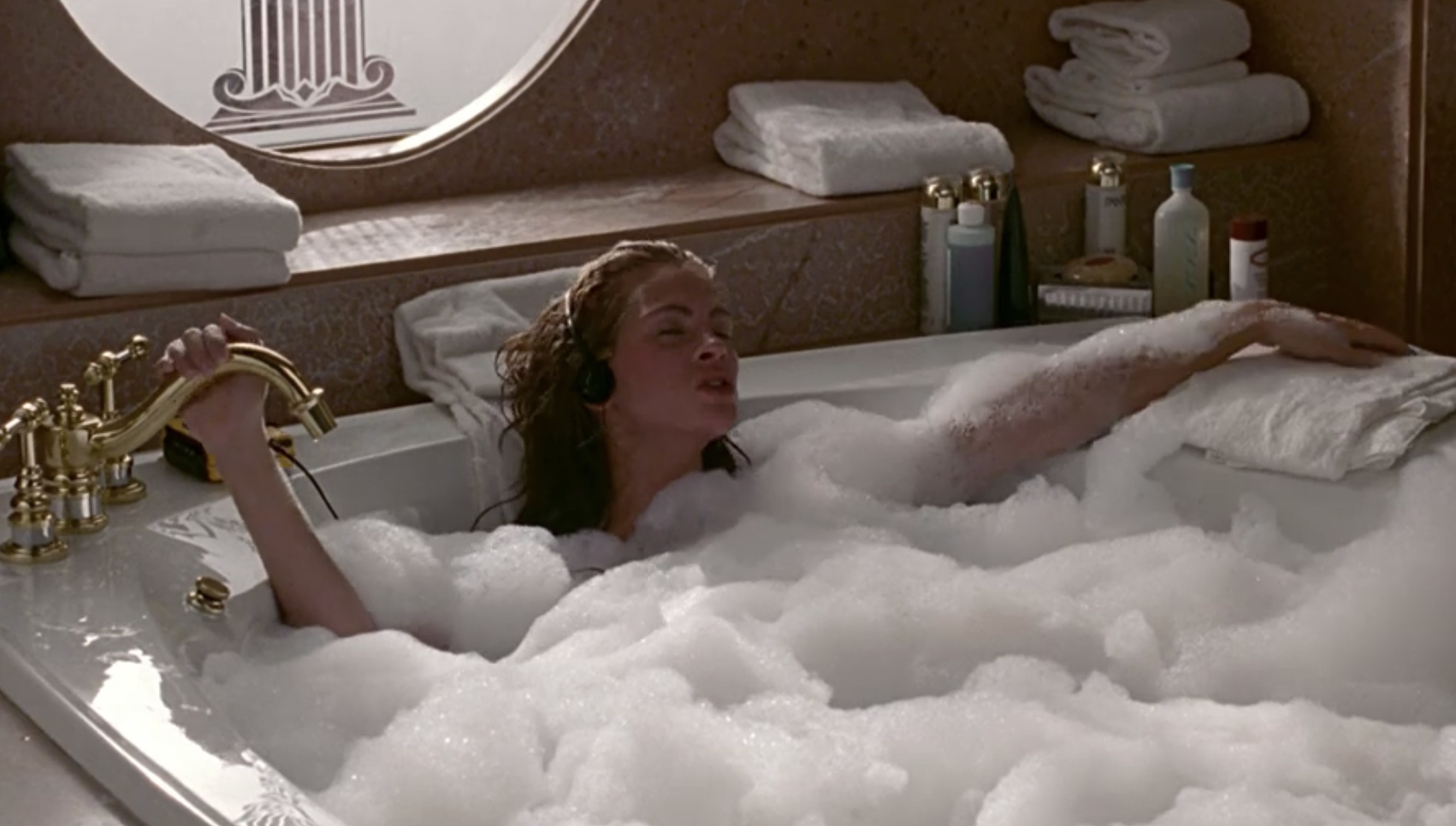 Actor Julia Roberts relaxes in a bathtub filled with bubbles.
