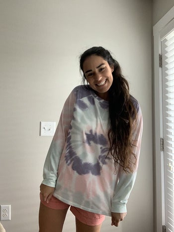 a reviewer in a pastel tie dye sweatshirt