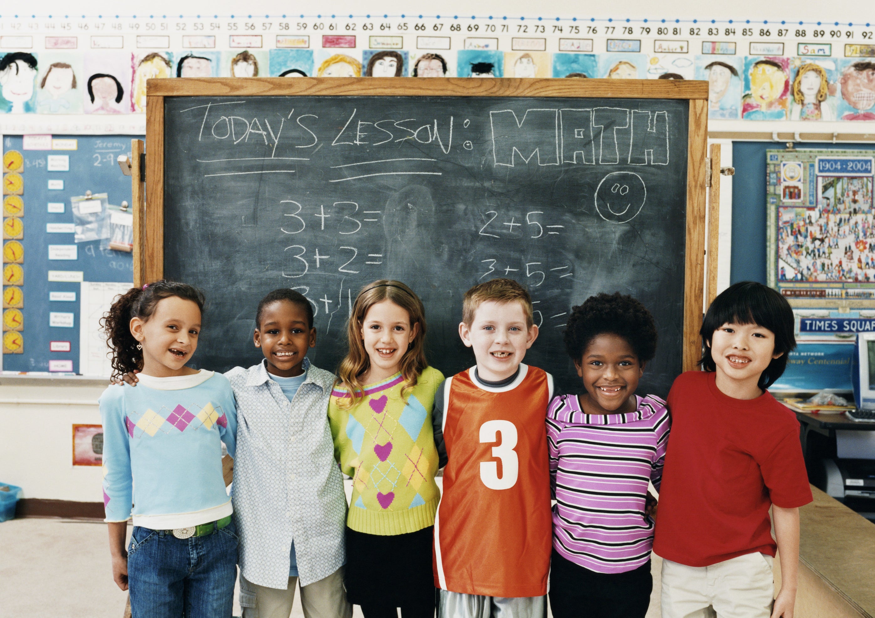 students standing front of a chalkboard with math problems