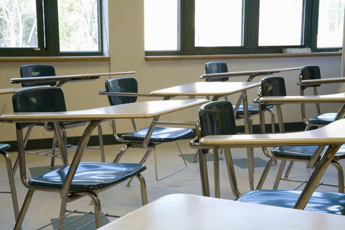 A row of empty desks in a classroom