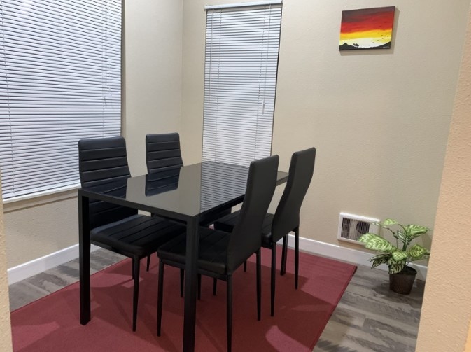 A reviewer&#x27;s image of a five-piece dining set with four chairs and a dining table