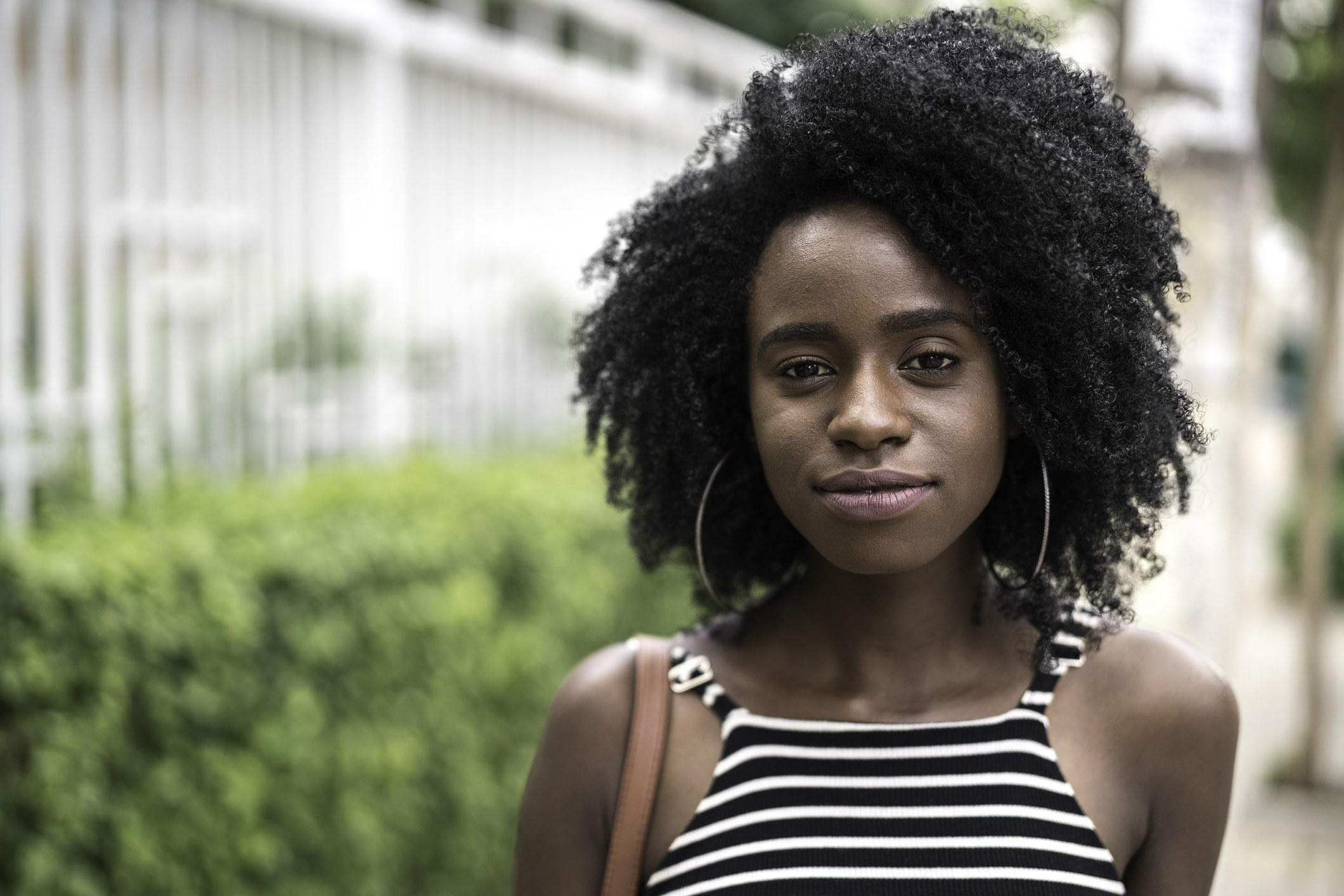 A Black female student with natural hair looks solemn