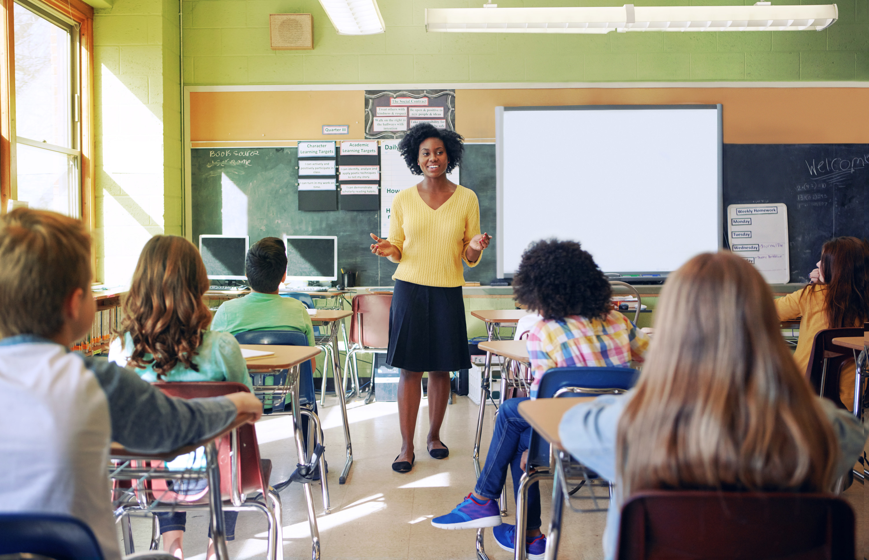 a teacher teaching her students in class