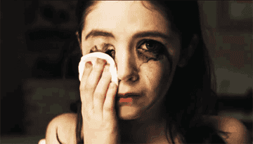 Esther wiping off makeup