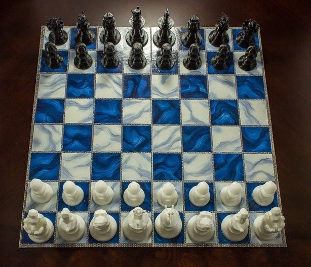 Blue and white chessboard with white and black Pokemon-inspired pieces