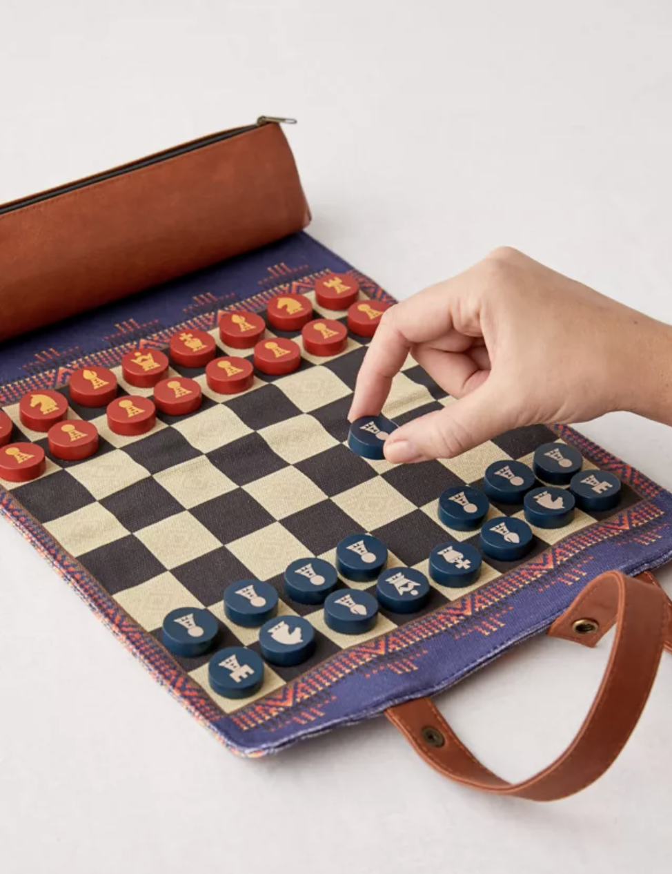 Model moving blue pawn on a fabric chessboard
