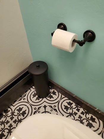 Reviewer's canister is shown in a corner of a bathroom