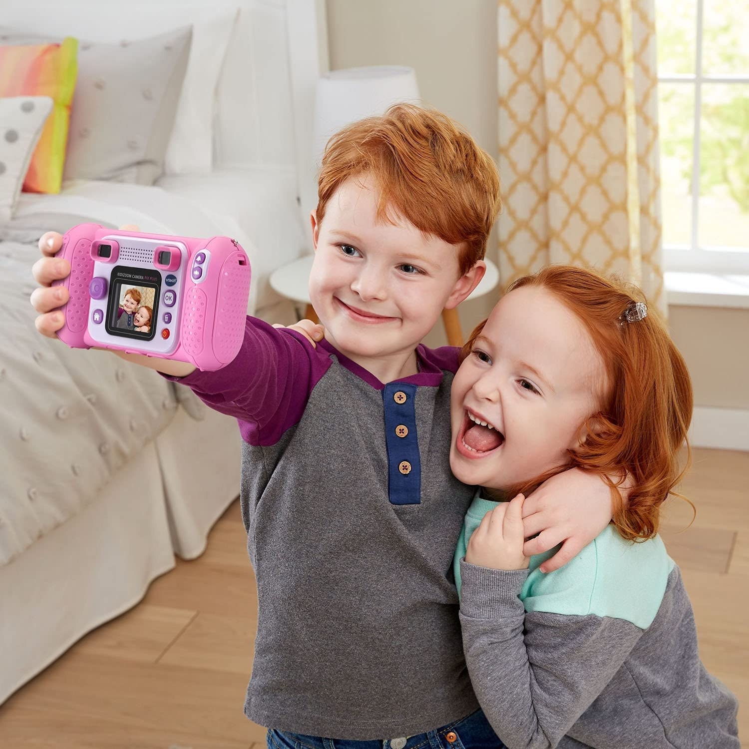 Two kids taking a selfie with the play camera