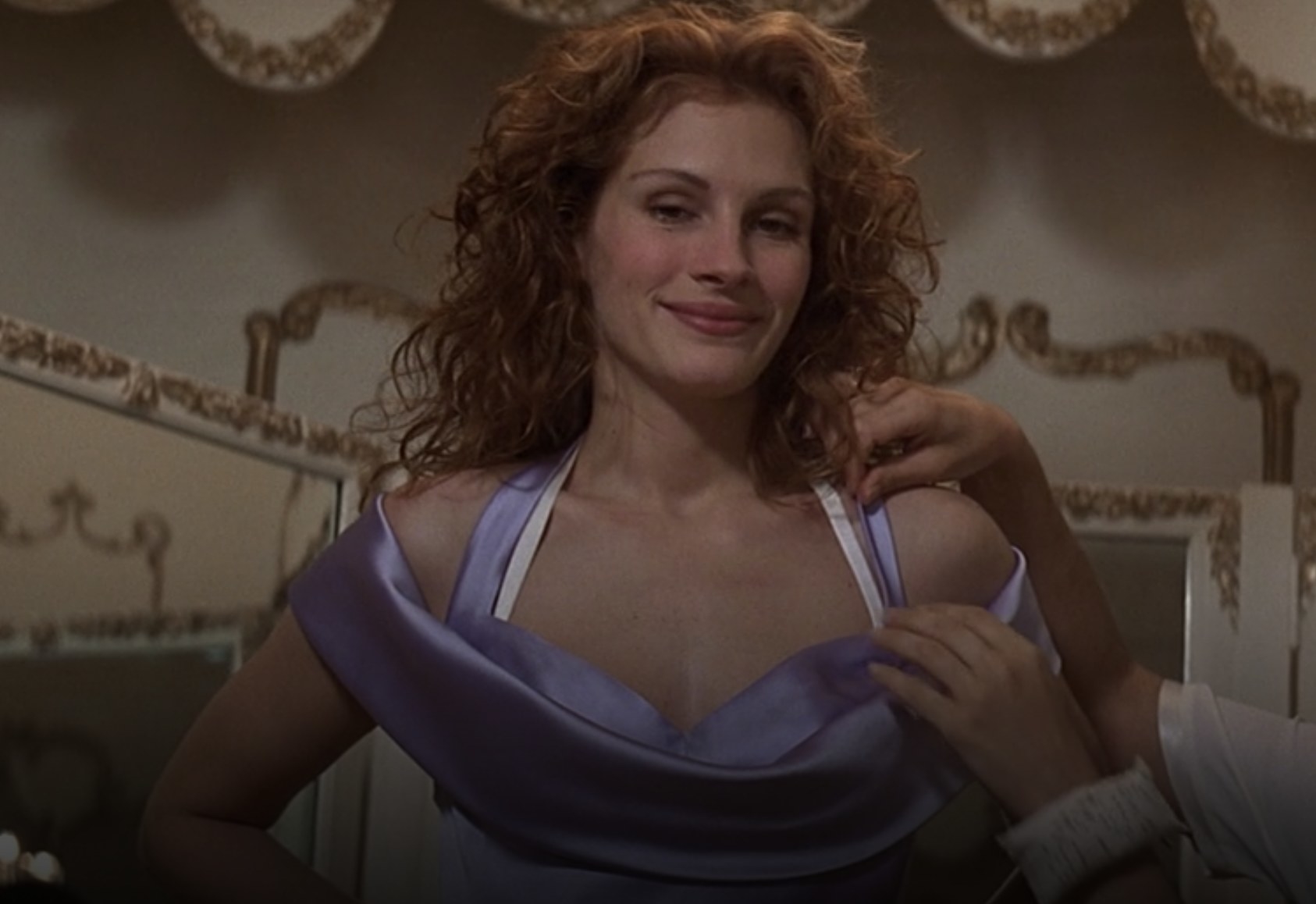 Actor Julia Roberts gets fitted for a purple gown and smiles.