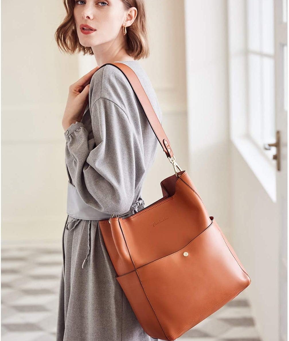 a person wearing the leather bucket bag with a dress