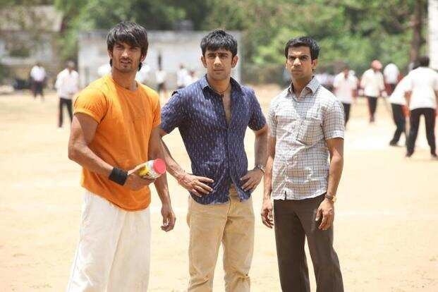 The male leads of Kai Po Che stare at someone in a still from the film.