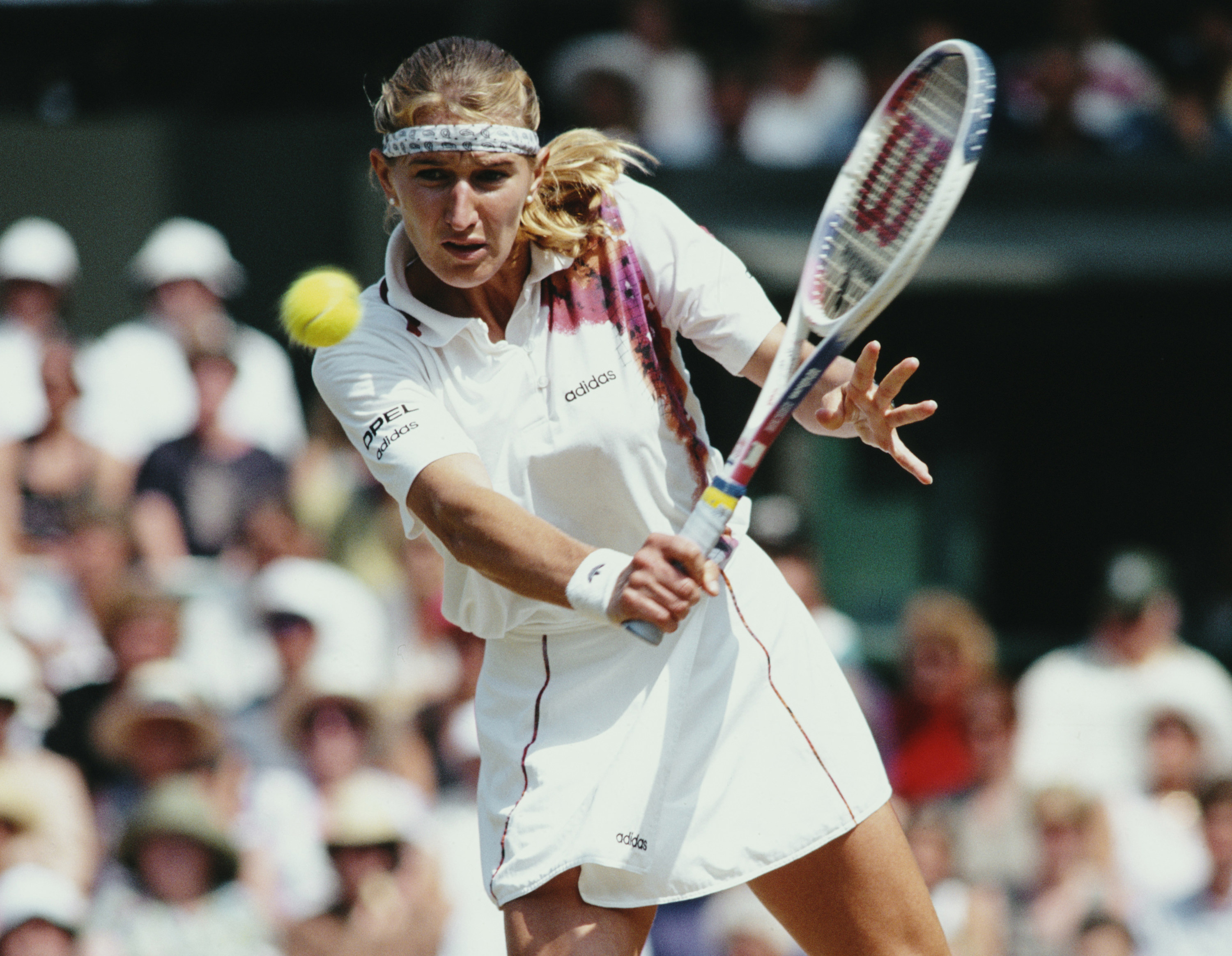 Steffi Graf of Germany makes a backhand return during the Women&#x27;s Singles Final of the Wimbledon Lawn Tennis Championship against Arantxa Sánchez Vicario