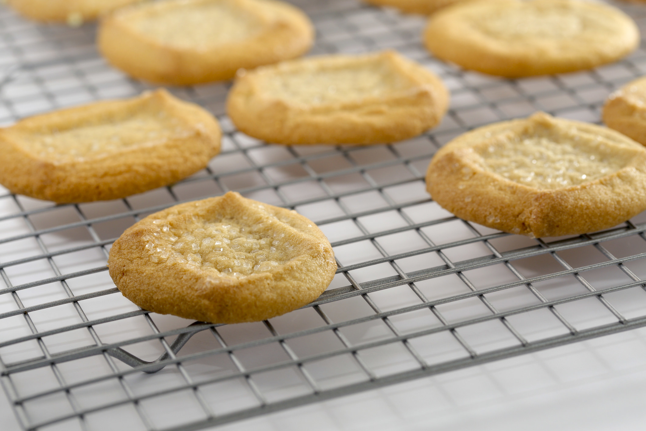 Sugar cookies on a cooling rack.