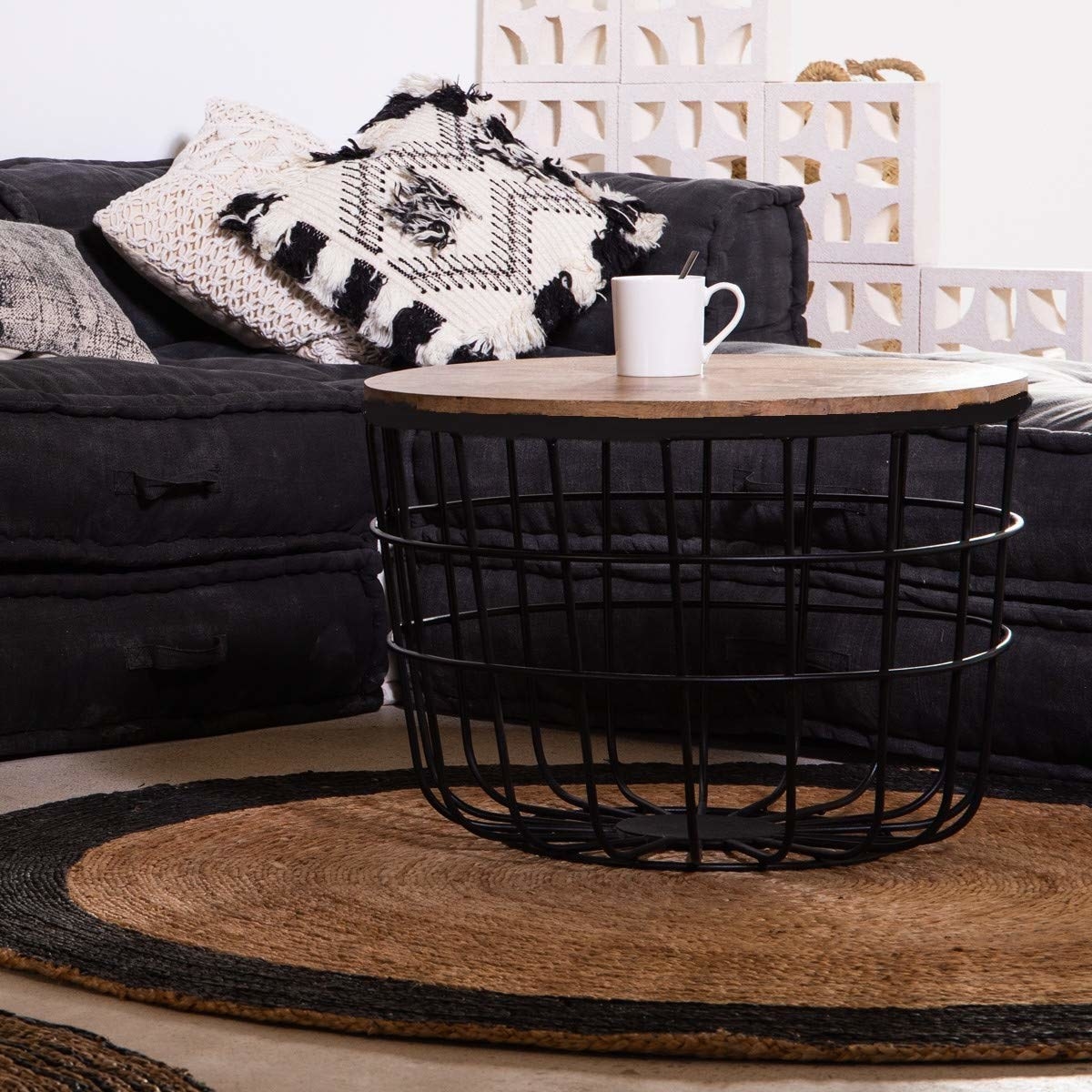 A coffee table with a coffee cup in front of a sofa
