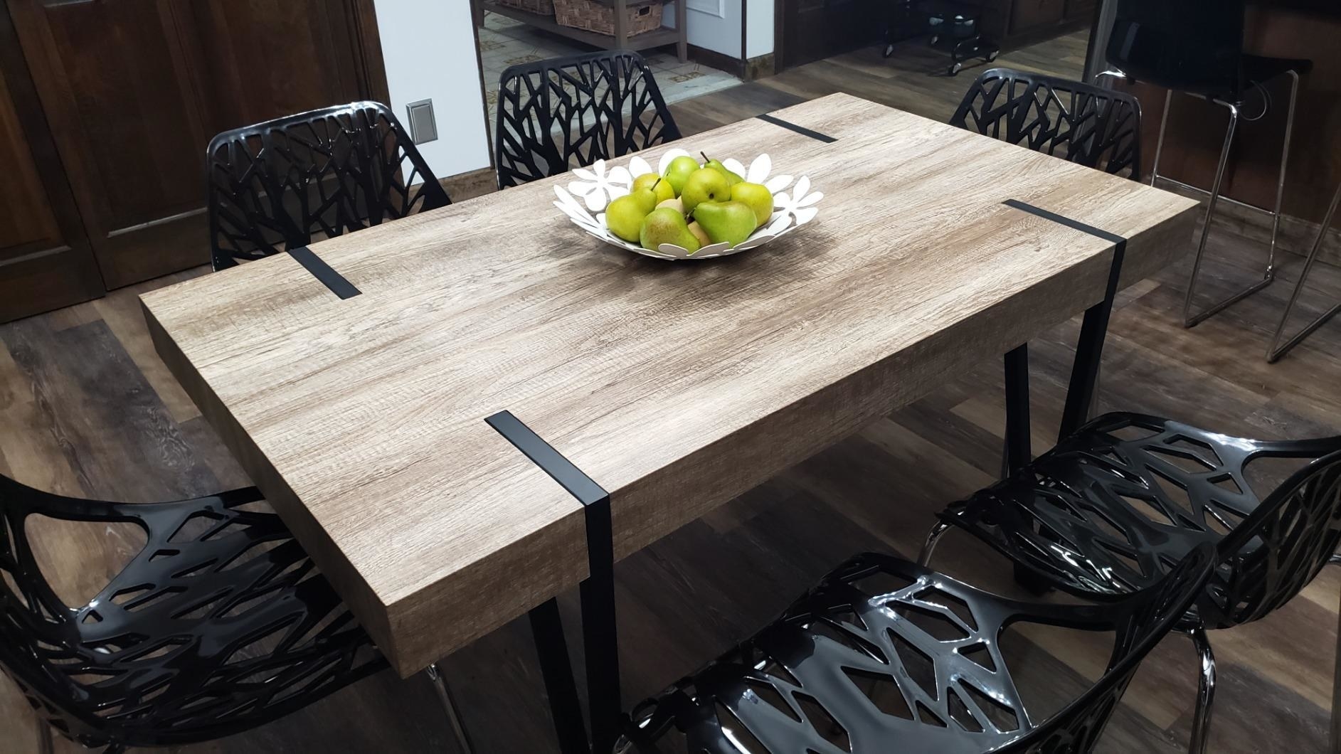 A reviewer&#x27;s image of a rustic industrial brown and black dining table