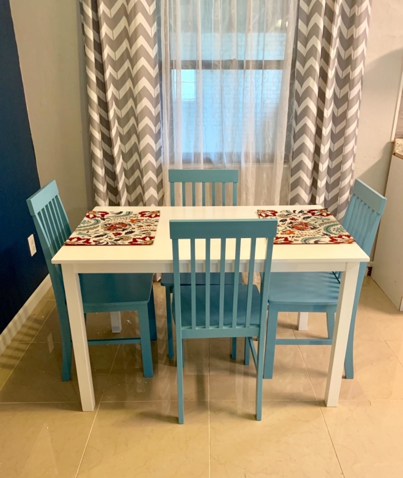 A reviewer&#x27;s image of a four-person modern farmhouse dining set