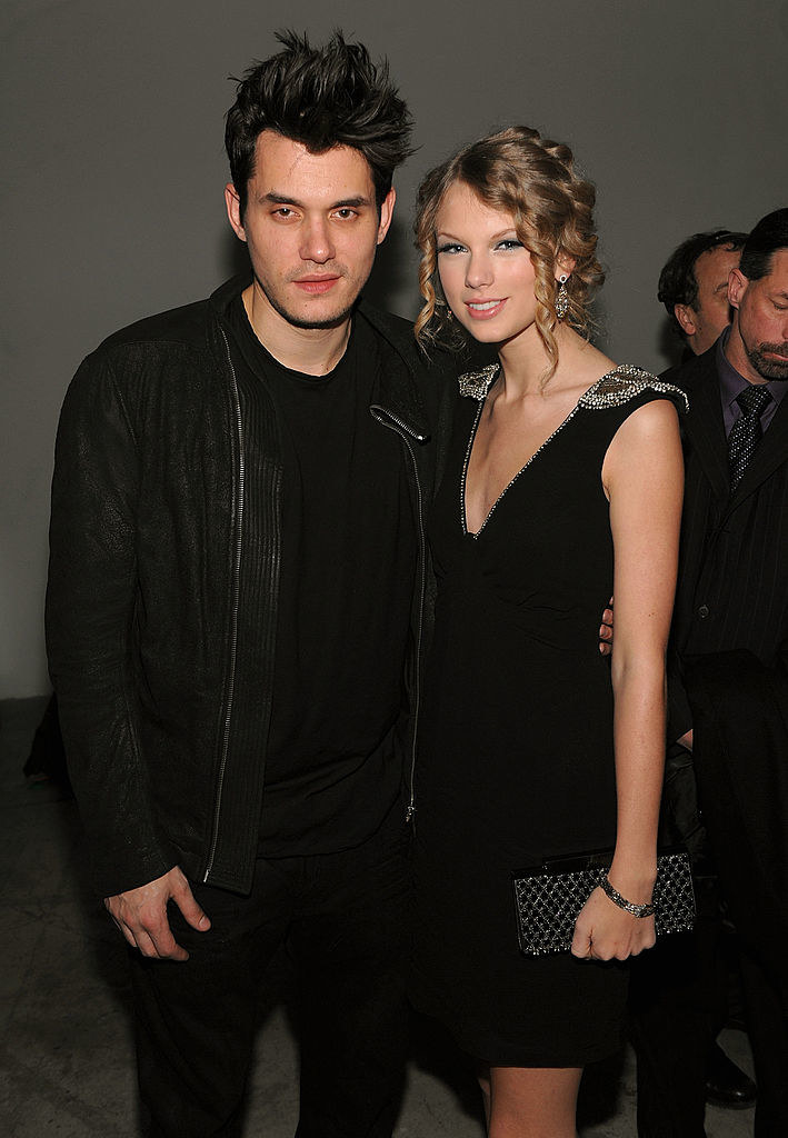 John with his arm around Taylor as they posed for a photo