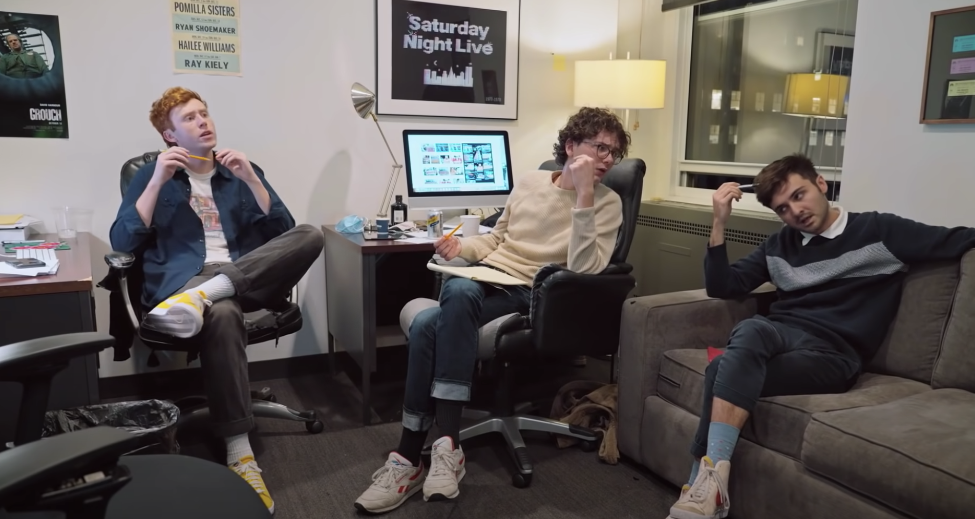 The trio sitting in an office