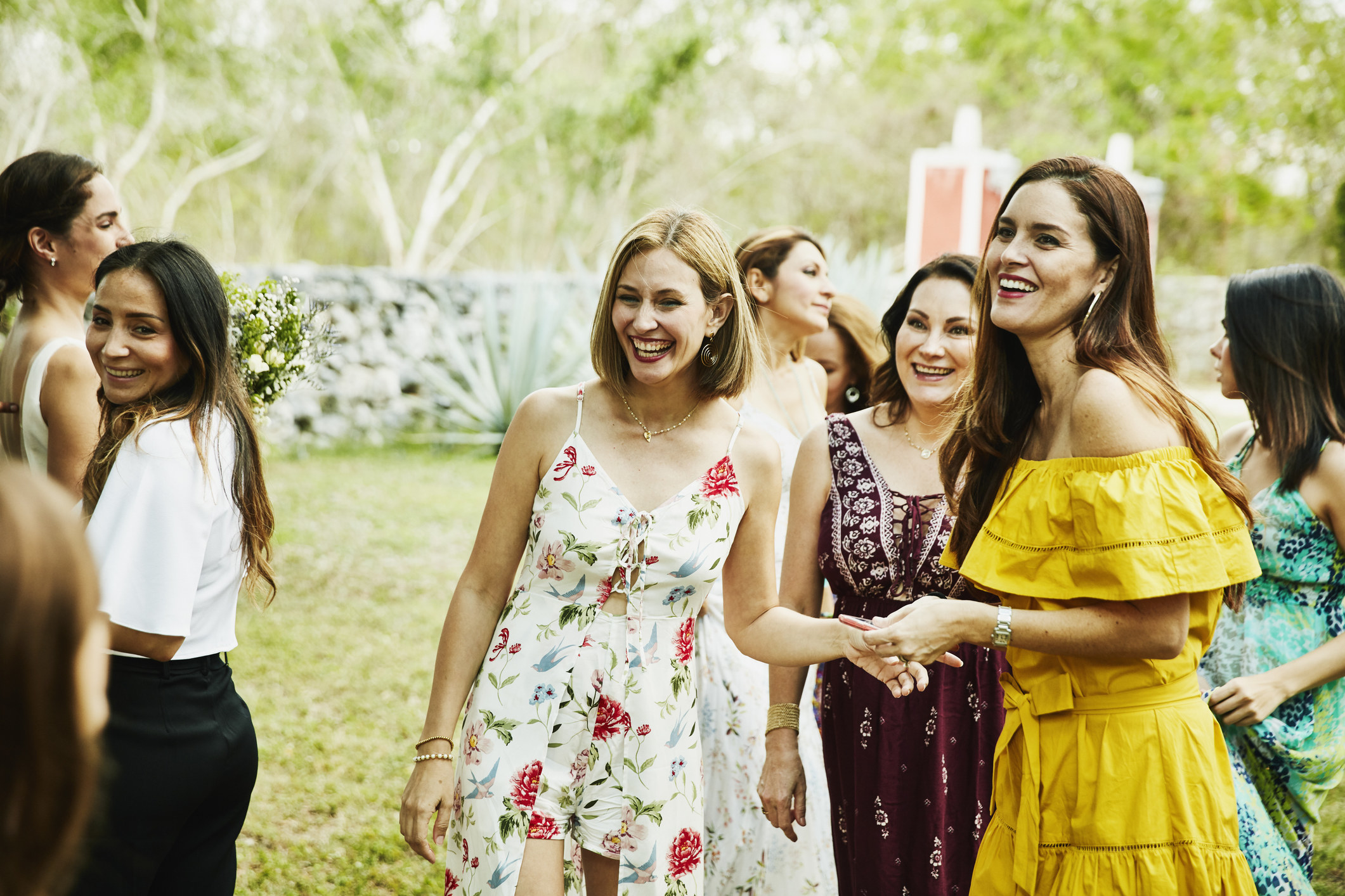 Several people at a wedding in summer dresses