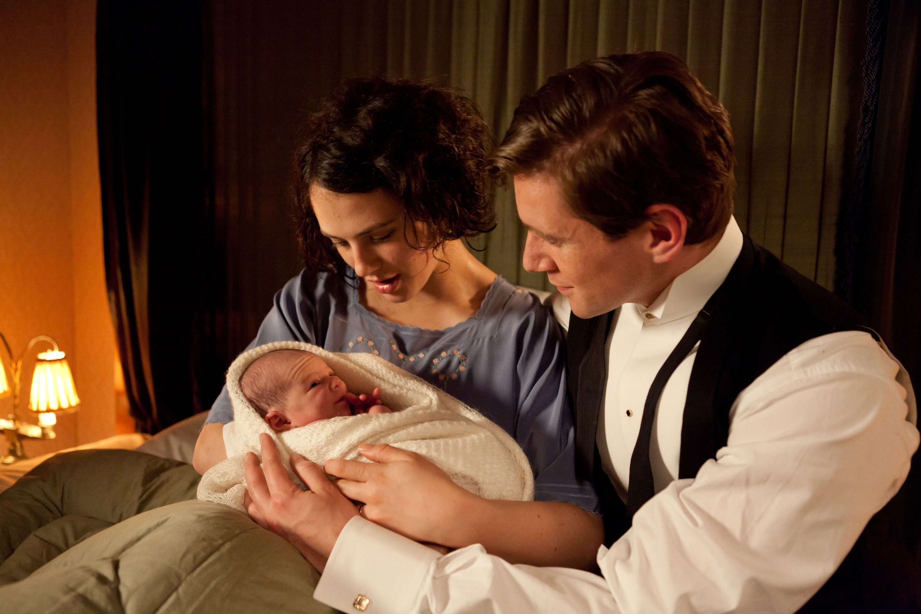 Sybil holding her baby beside Tom