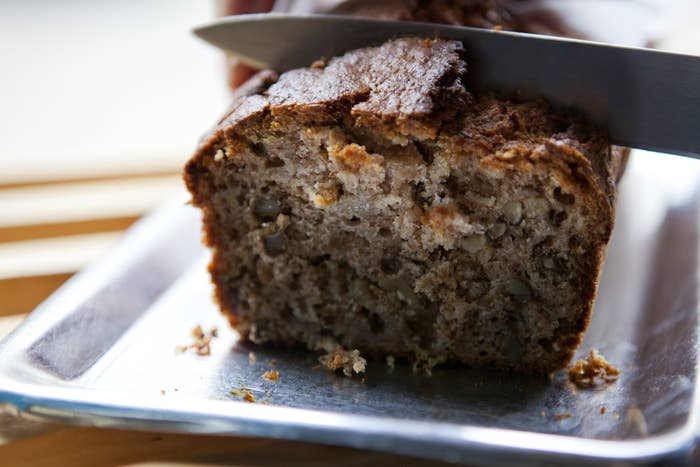 Slicing into a loaf of banana bread.