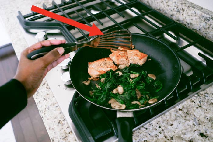 Flipping salmon with a fish spatula.