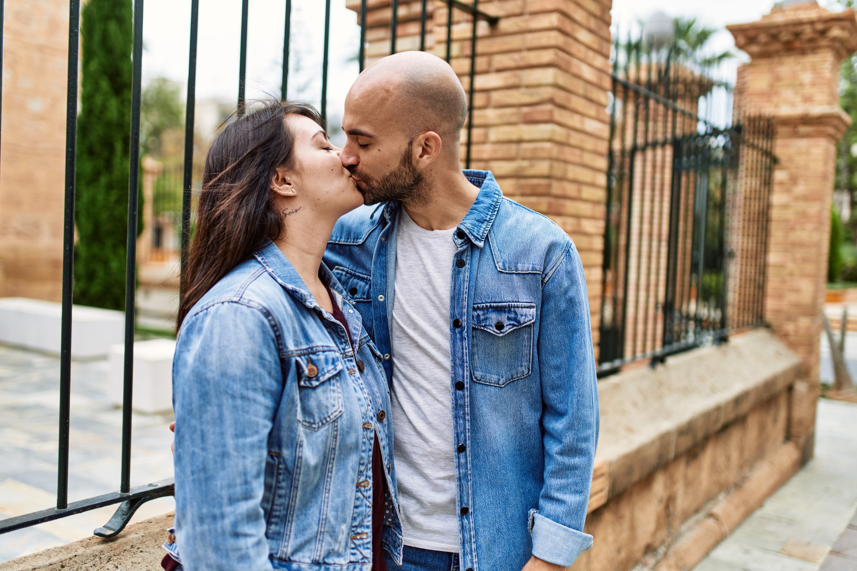 Two people kissing outdoors