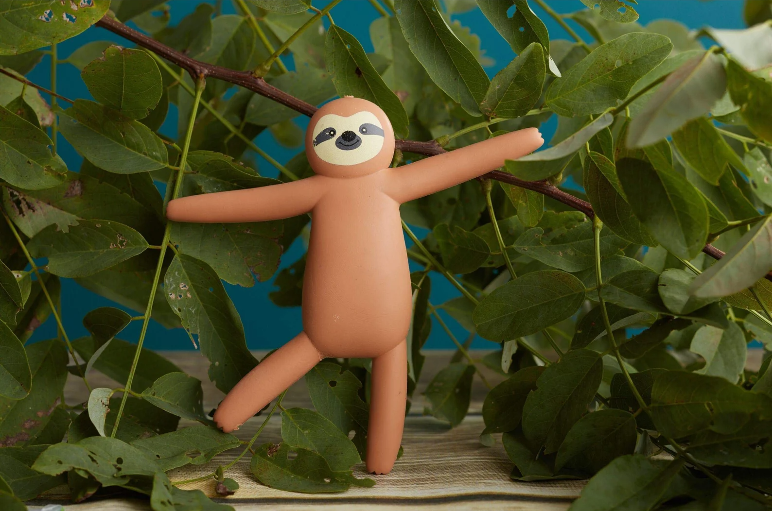 Toy sloth figure with arms wide open