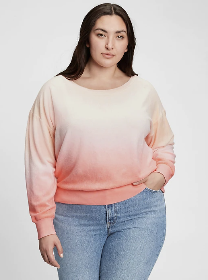 model wearing a pink and white ombre sweatshirt