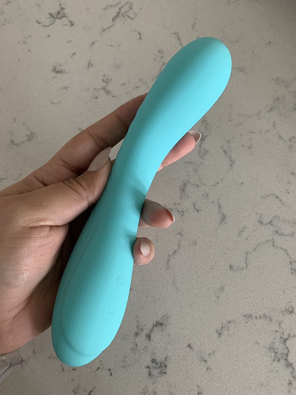 Reviewer holding aqua vibrator