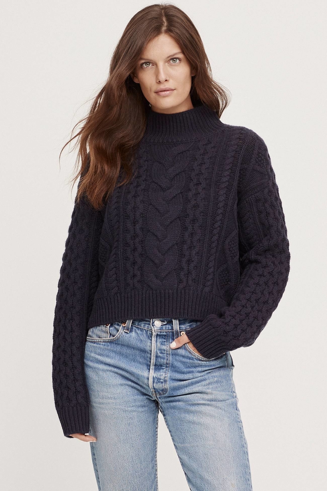 model wearing the cropped cable-knit sweater in navy