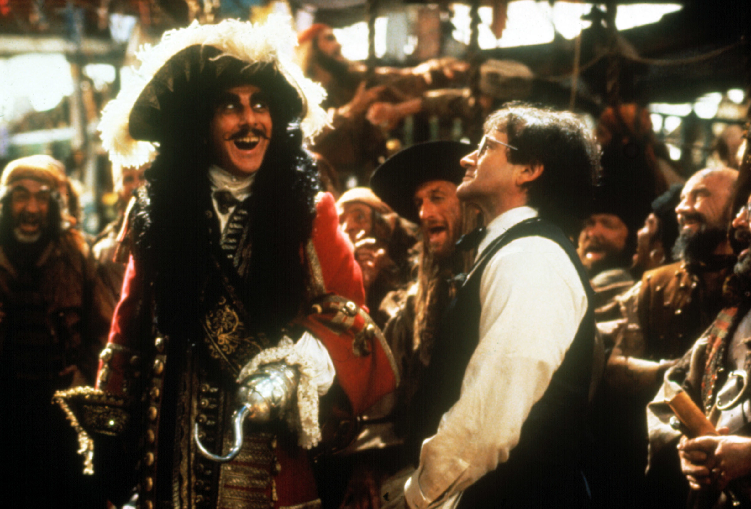 Dustin Hoffman as Captain Hook and Robin Williams standing in front of him.
