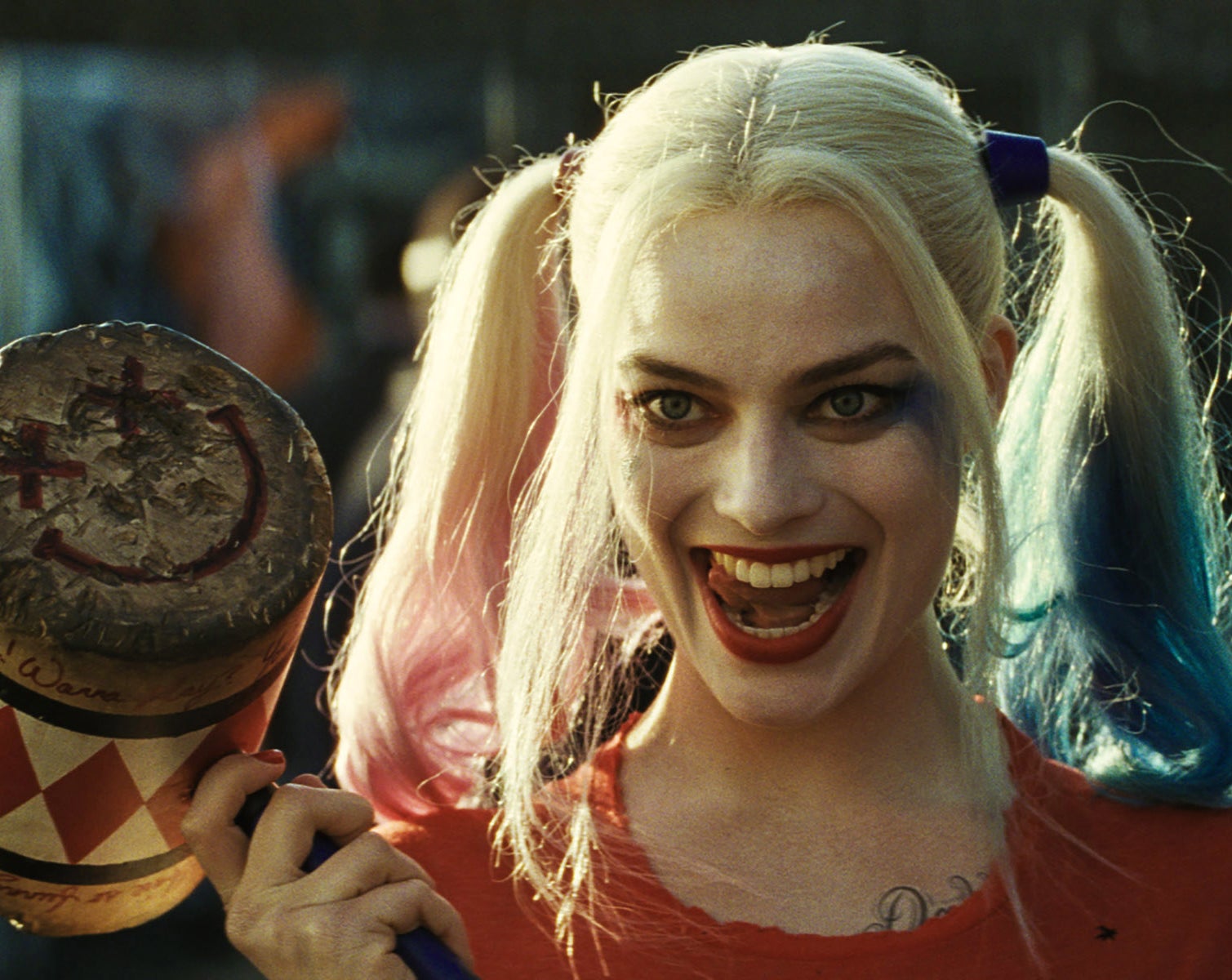 Margot Robbie as Harley Quinn holding a mallet