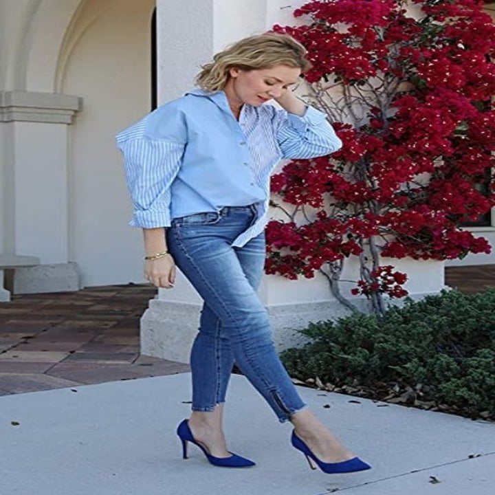 A model wearing the same closed toe pointed stilettos in royal blue