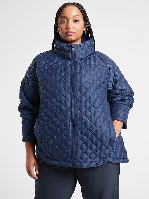 model wearing the quilted jacket in blue