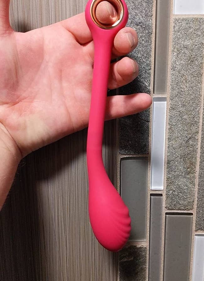 Reviewer holding pink vibrator