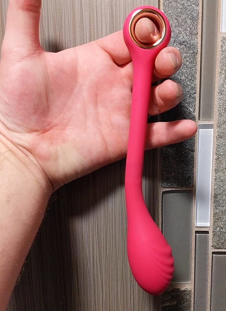 Reviewer holding pink vibrator